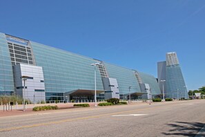 A modern building with a glass facade and a unique angular design. - The Colony Virginia Beach by TripForth (Virginia Beach)