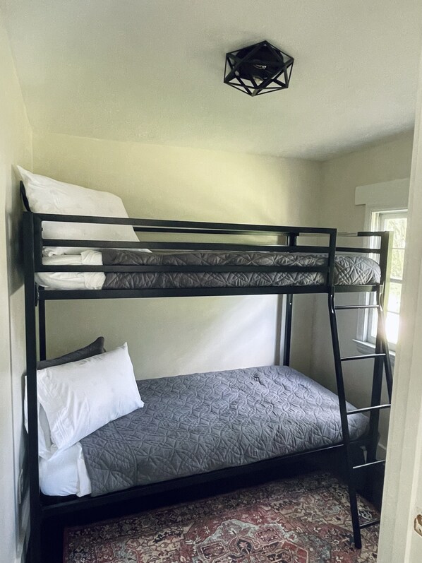 A bunk bed with a patterned mattress, pillows, and a ladder. - {Das Vogel Haus}
Cheerful cottage getaway in Helen (Helen)