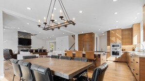 A modern kitchen with a central island, wooden cabinets, and stainless steel appliances. - Healdsburg Modern home, 3BR/3.5BA pool, hot tub, outdoor kitchen, WiFi (Healdsburg)