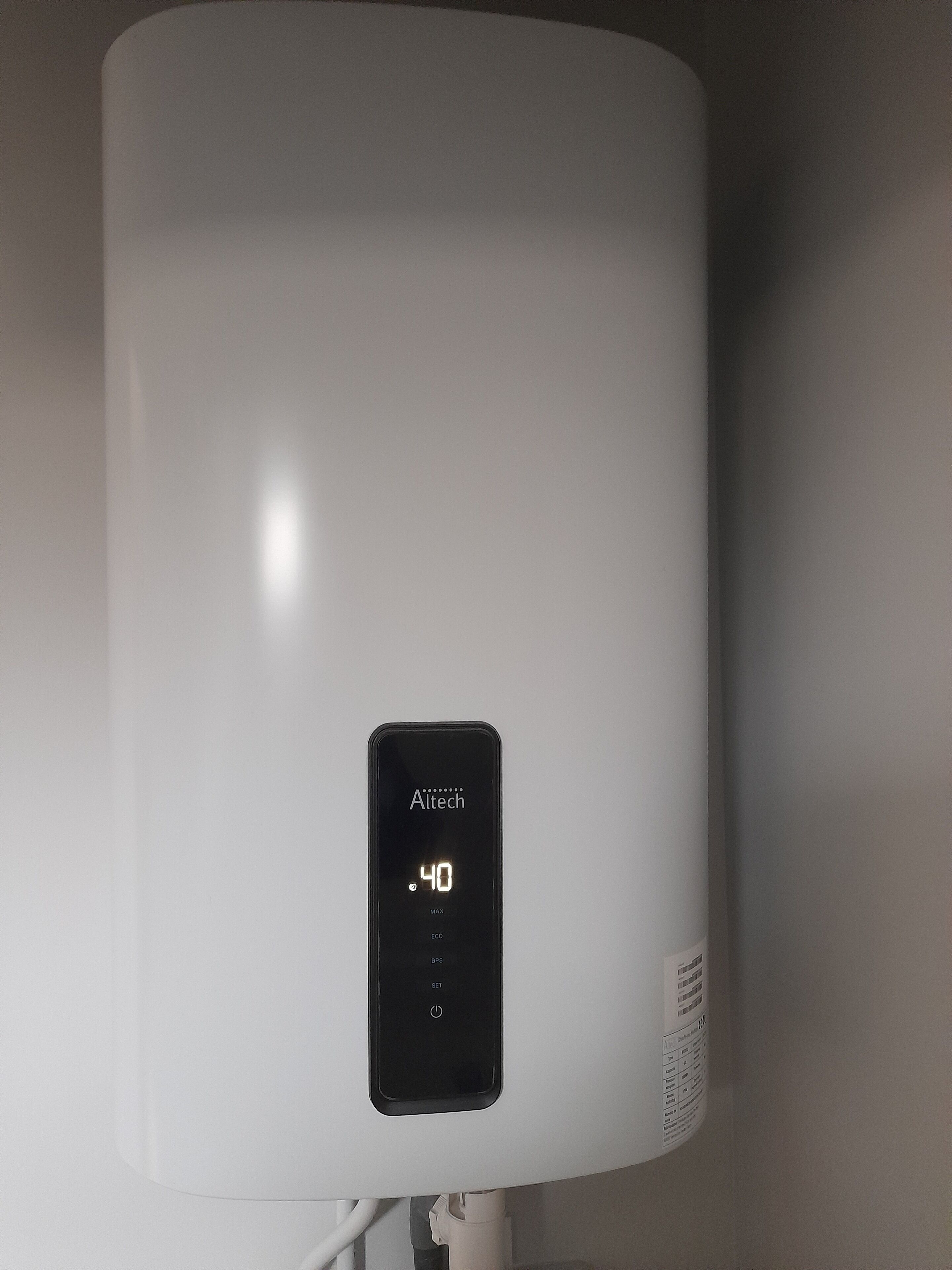 A white, modern, cylindrical device with a digital display reading "Altech 40 MAX ECO" and a power button below.