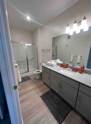 Shower, hair dryer, towels, toilet paper