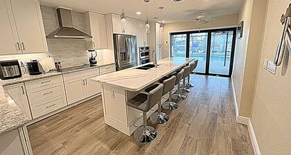 "DOUBLE CAPE ESCAPE"...PRIVATE WATERFRONT OASIS W/HEATED POOL, DOCK & PATIO BAR