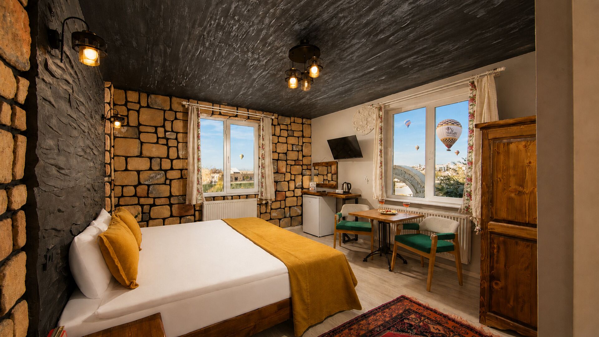 A room with a bed, a desk, a chair, and a view of the outside.