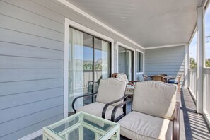 Relax in a comfortable outdoor space with a sofa, armchairs, and table.