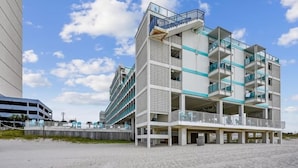 A multi-story hotel with balconies, a beach view, and a parking structure nearby. - Studio condo on beach at Historical Fontainebleau Terrace. Sleeps 4.Full Kitchen (Panama City Beach)