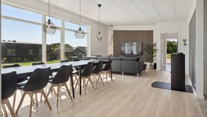 A modern kitchen with a dining area, large windows, and a TV. - Pet friendly home in Børkop with WiFi (Børkop)