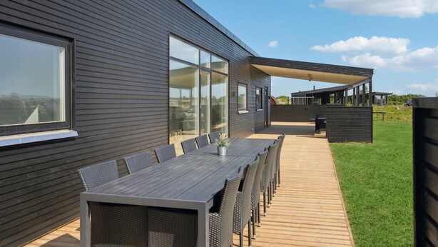 A modern house with a deck, large windows, and a covered outdoor seating area. - Pet friendly home in Børkop with WiFi (Børkop)