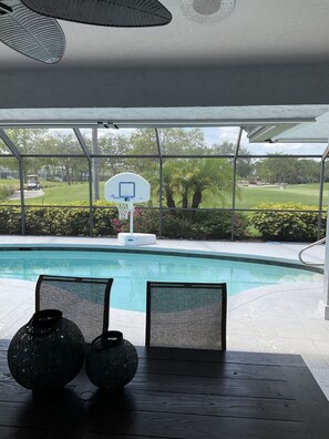 Enjoy a serene view of the pool and golf course from the comfort of your room.