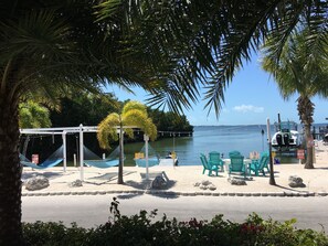 A beachside area with a gazebo, hammocks, and beach chairs. - Key Largo Relaxing Gataway with Stoning Sunsets Views (Key Largo)