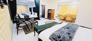 Deluxe Quadruple Room | Premium bedding, laptop workspace, free WiFi, bed sheets - Grand Taj Hotel  (Murree)