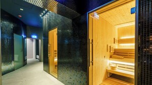 A hallway with a sauna area, tiled walls, and wooden benches. - Factory Resort Wellness & SPA (Kolobrzeg)