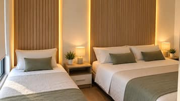 A hotel room with two beds, wooden headboards, bedside tables with lamps, and a small potted plant.