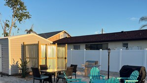 A patio area with outdoor furniture, a grill, and a fenced yard. - CLEAN,Great Location,Dockage Available,HEATED Pool, HUGE Back yard. Unit C  (Englewood)