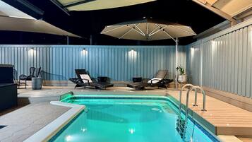 Outdoor pool, a heated pool, pool umbrellas, pool loungers