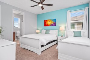 Cozy retreat with a large bed, bedside tables, and a ceiling fan for a comfortable stay.