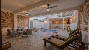 A spacious outdoor area with a pool, lounge chairs, and wicker furniture. - Casa La Paz with pool, patio and bbq grill (La Paz)