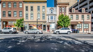 A street view with a building labeled "International House" featuring a prominent sign, a parked car, and a clear blue sky. - Quirky Downtown Loft (Harrisburg)