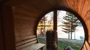 A wooden cabin with a bench and a fireplace.