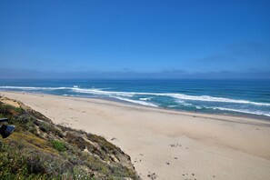A beach with a clear view of the ocean and a sandy shoreline. - Just a few steps to stairs to ocean! Gated. The Sanctuary at South Sierra (Solana Beach)