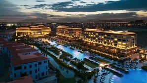 A large hotel with multiple swimming pools and a well-lit exterior. - Family-Friendly3BRVilla•BRGGolfView•PrivatePool•NearSea•FreePickup(5 Nights+) (Da Nang City)