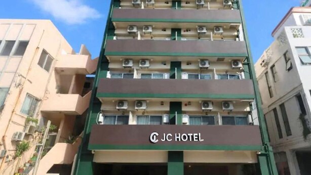 A multi-story hotel building with balconies and air conditioning units. - JC HOTEL NAHA (Naha)