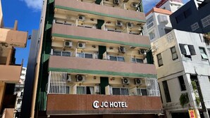 A multi-story hotel with balconies, air conditioning units, and a visible sign reading "JC HOTEL". - JC HOTEL NAHA (Naha)