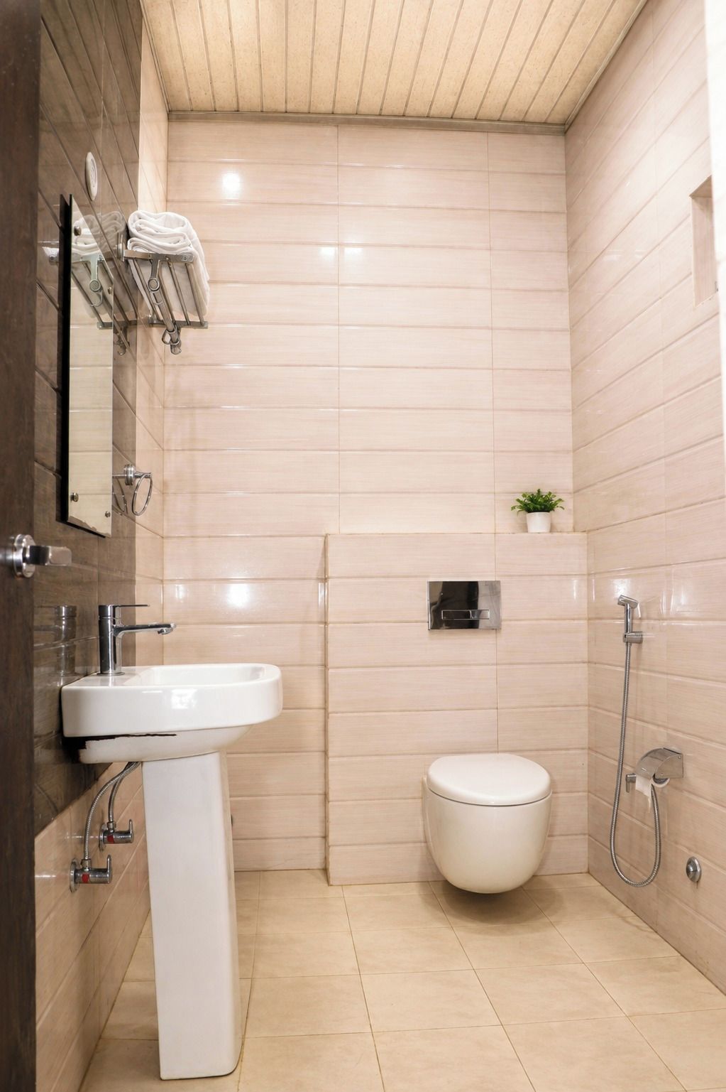 A modern bathroom with a white sink, toilet, and shower.