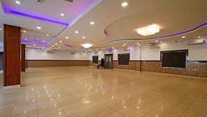 A spacious hall with a polished tile floor, recessed lighting, and a ceiling fan. - Hotel YashoGopal Resortico (Mathura)