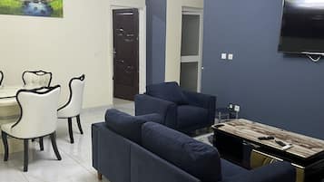 Luxury Apartment | Living area | 50-inch flat-screen TV with cable channels, TV