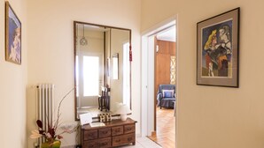 A room with a wooden dresser, a mirror, a radiator, and a vase with plants. - Tati's Parthenon apt 2bdr/1,5bthr/100Mbps VDSL- 5mins walk to Acropolis (Αθήνα)