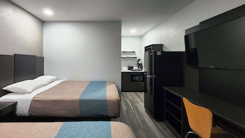 Desk, laptop workspace, blackout drapes, iron/ironing board