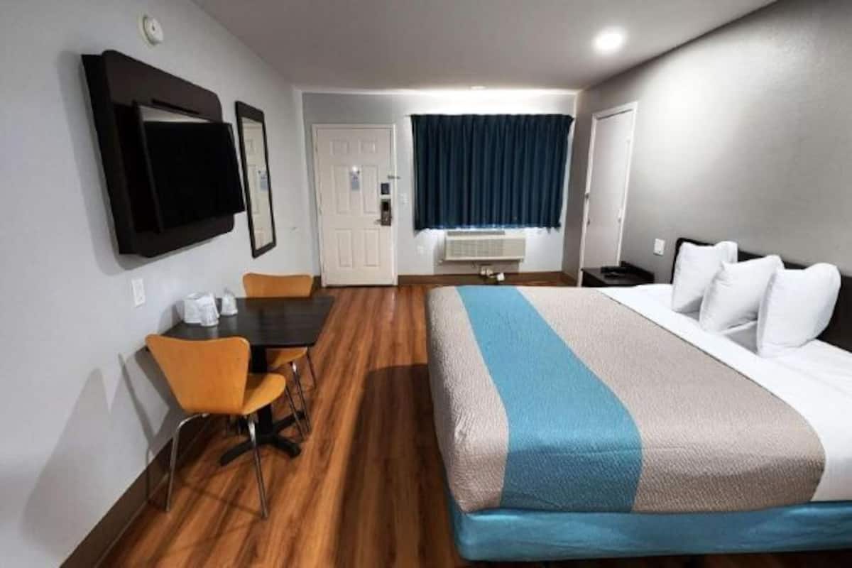 Desk, laptop workspace, blackout drapes, iron/ironing board