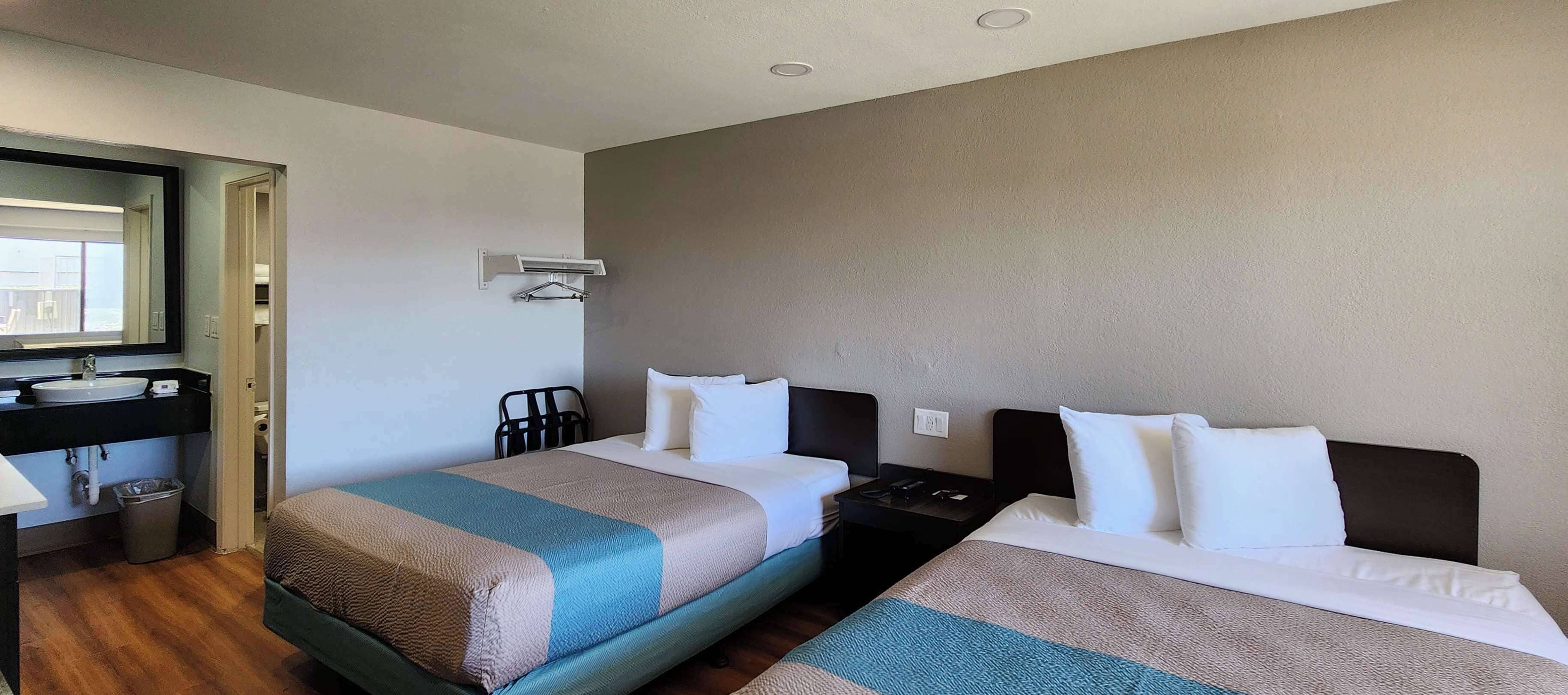 Desk, laptop workspace, blackout drapes, iron/ironing board