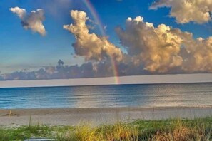 A beach with a clear sky, a rainbow, and clouds. - Beachfront Coastal Cottage St George Island (St.George Island)