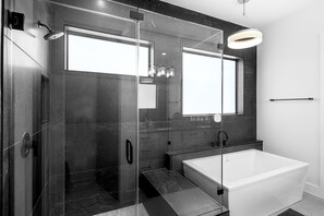 Bathtub, hair dryer, towels, shampoo