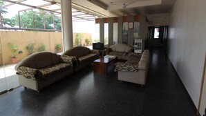 A spacious lobby with a sofa set, a coffee table, and a television. - Hotel Sumanchandra Suites  (Nashik)