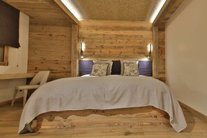 Une pièce en bois avec un lit, une chaise et une fenêtre.