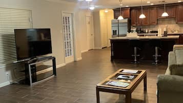 Smart TV, fireplace, books, computer monitors