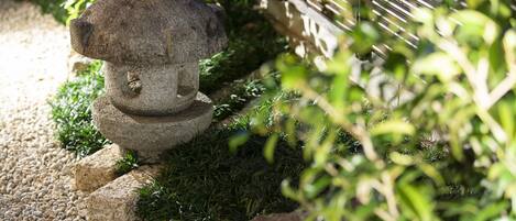 A stone lantern in a garden setting.