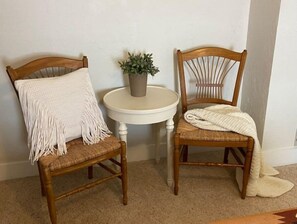 Two comfortable chairs and a small table create a cozy seating area.
