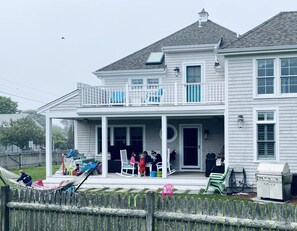 Enjoy outdoor dining and socializing on the covered porch, complete with a grill and comfortable seating.