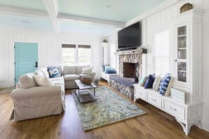 Cozy living room with a classic design, featuring a beige sofa, wooden coffee table, and ornate rug.