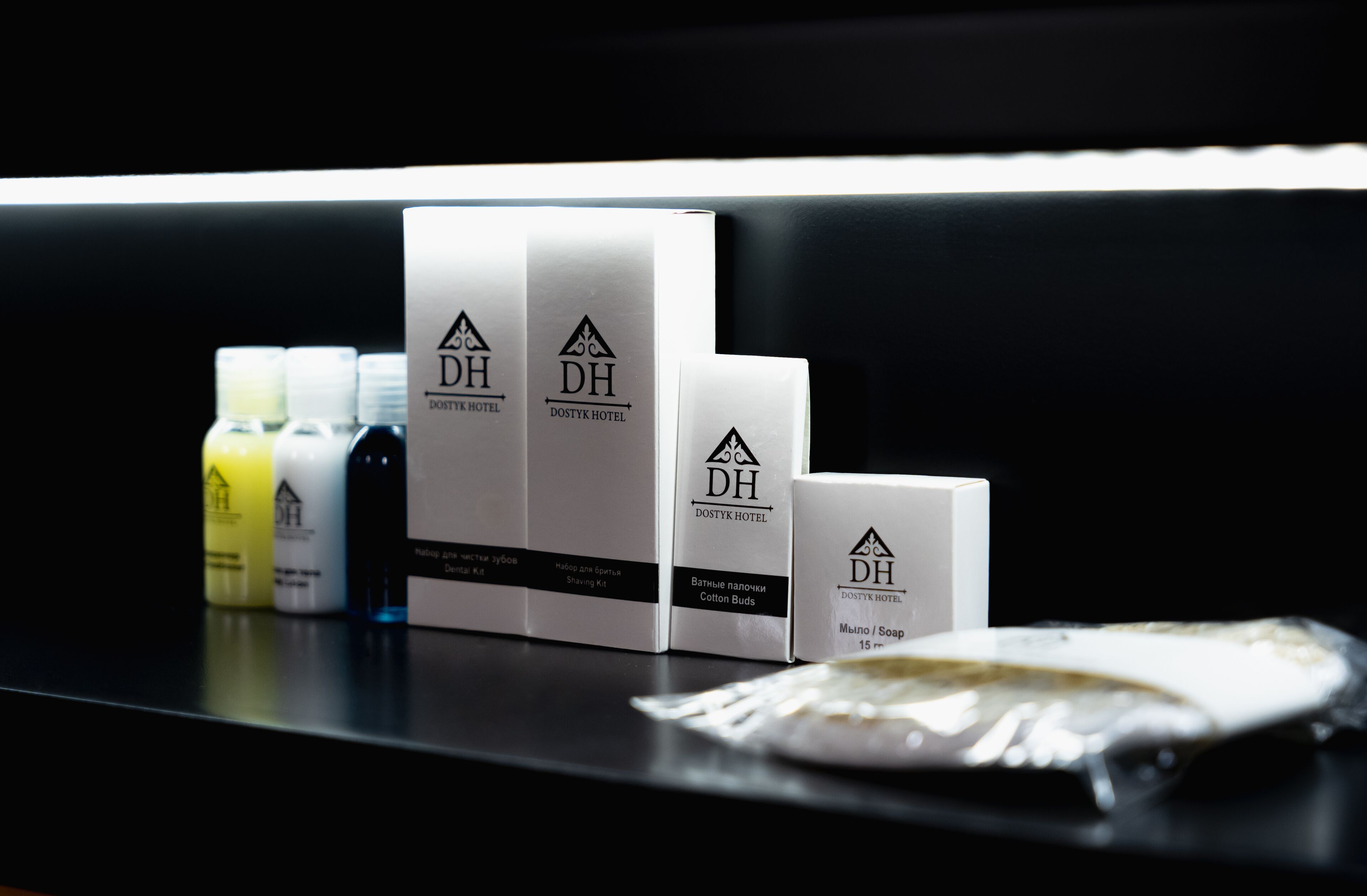 A display of toiletries including a cotton buds box, a soap bar, and several bottles of liquid soap.