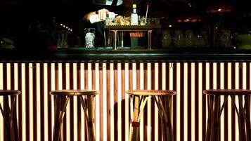 A bar area with stools and a bar counter.