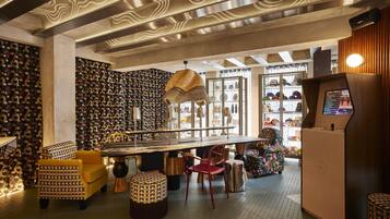 A modern interior with a bar area, patterned walls, and unique furniture.
