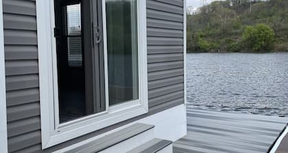 Waterfront Glamping Escape — Cozy Floating Cottages on the Peaceful Beaver River