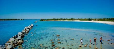 Ligstoelen aan het strand, strandlakens, vissen