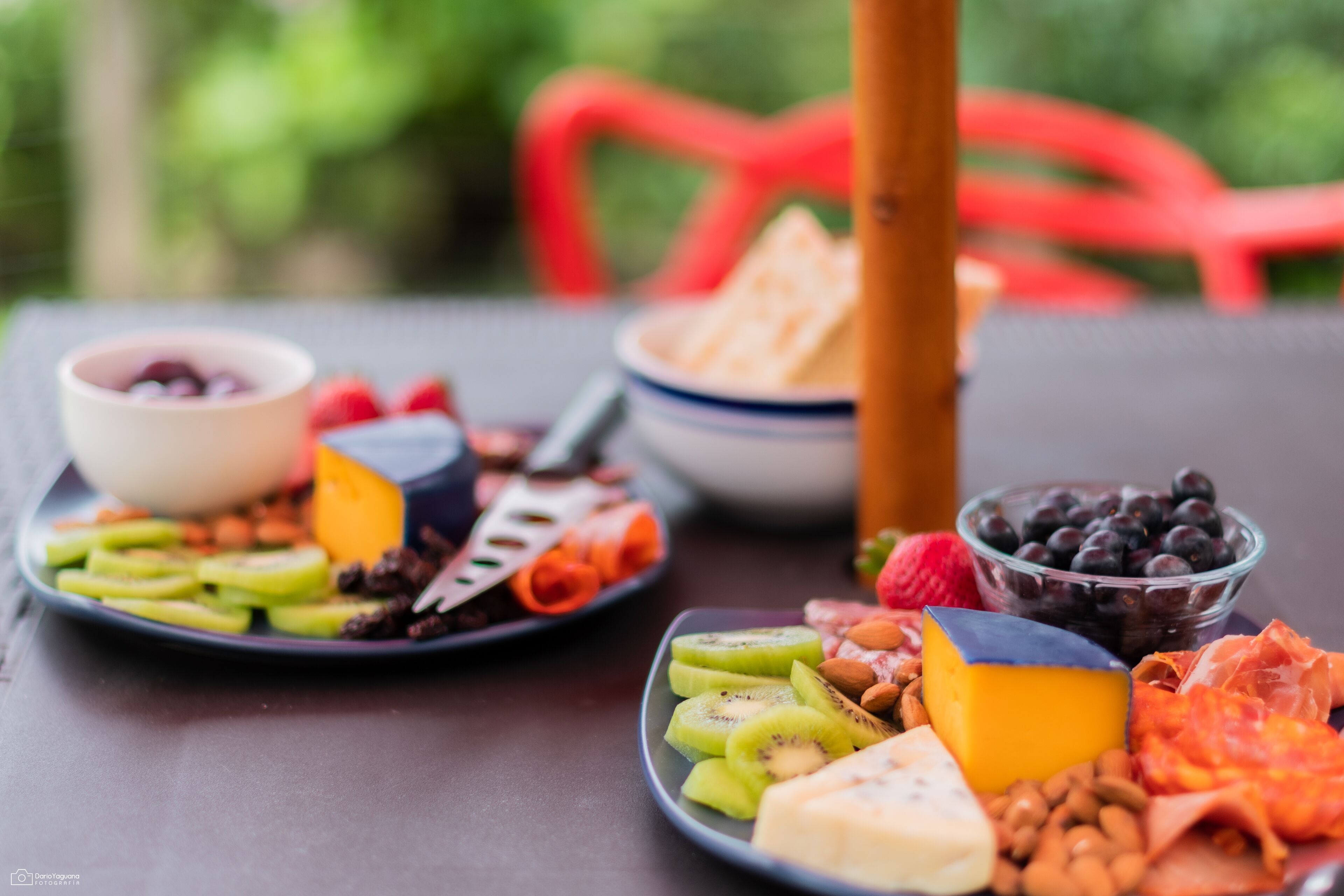 A table with various food items including fruits, cheese, and nuts.