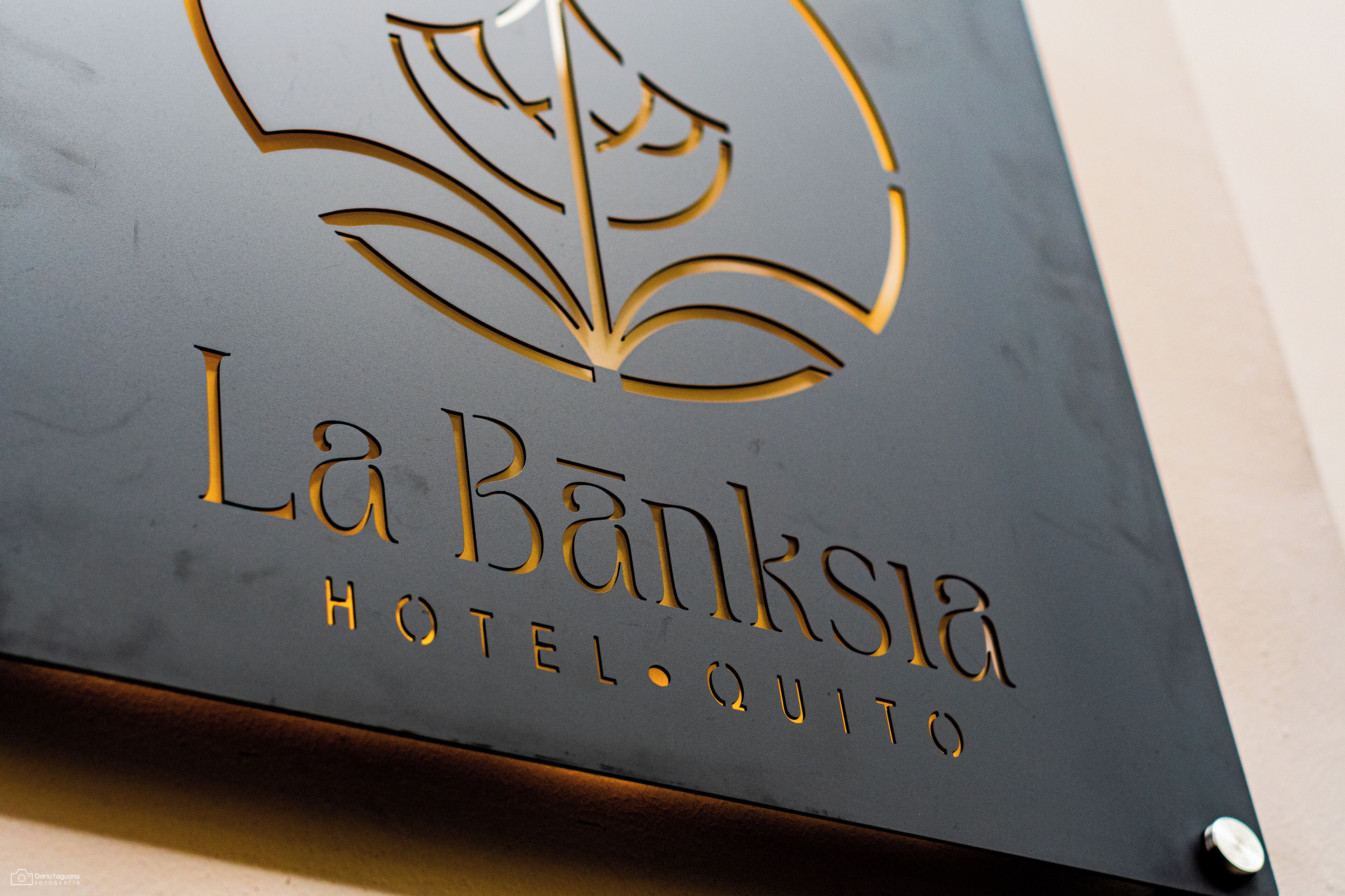 A sign with the name "La Banksla Hotel" and a floral design.
