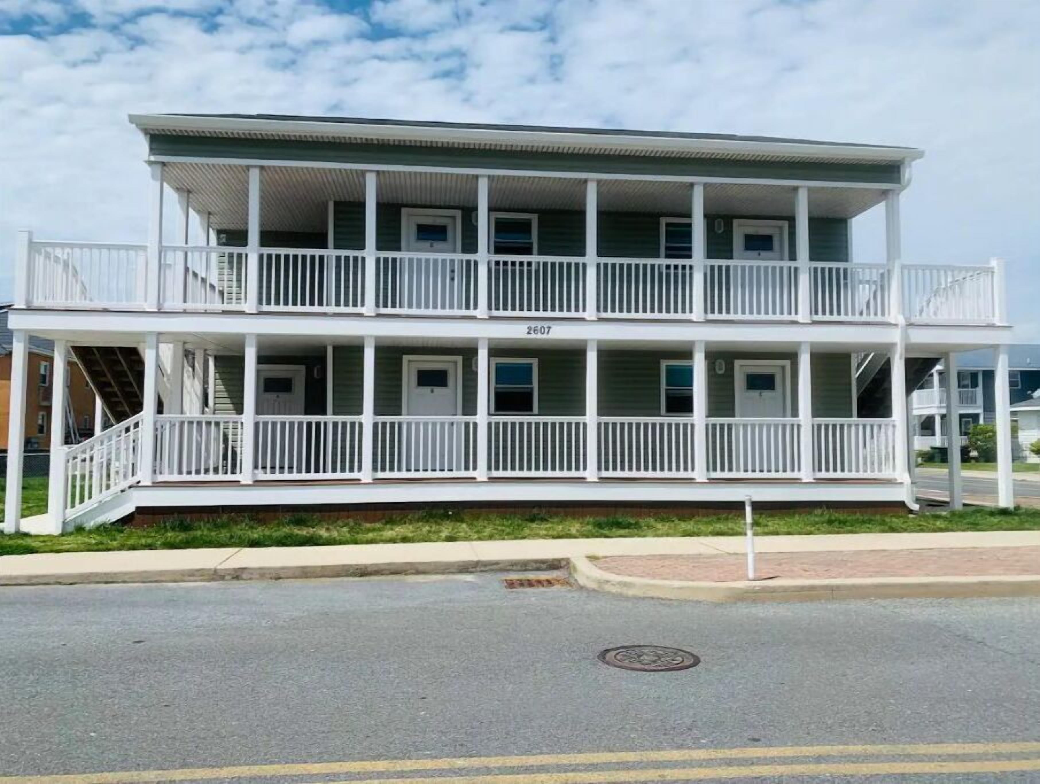 A two-story building with a balcony on the upper floor, numbered 2607.